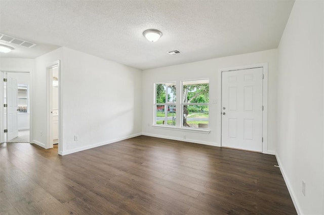 2233 SW 40th St, Oklahoma City, OK 73119 - unfurnished room with dark wood-style floors, baseboards, and a textured ceiling