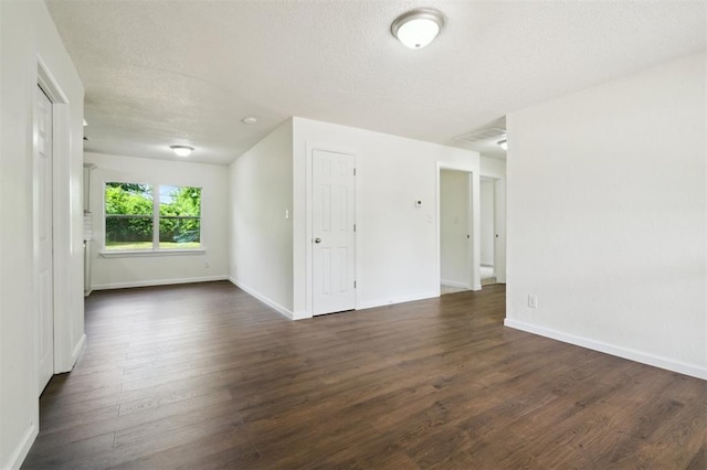 2233 SW 40th St, Oklahoma City, OK 73119 - empty room featuring dark wood-style floors, baseboards, and a textured ceiling