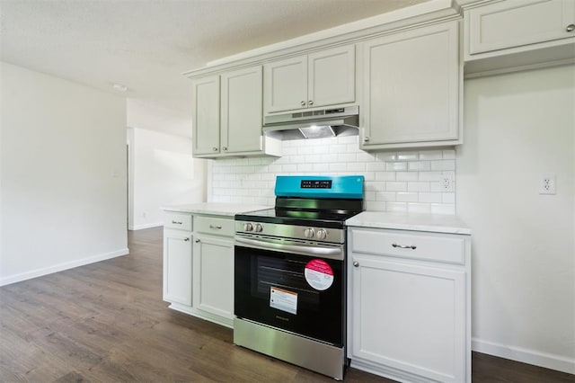 2233 SW 40th St, Oklahoma City, OK 73119 - kitchen with stainless steel electric range, under cabinet range hood, decorative backsplash, light countertops, and dark wood-type flooring