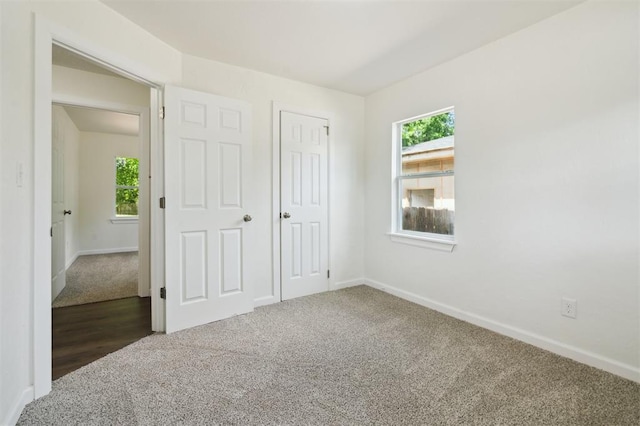 2233 SW 40th St, Oklahoma City, OK 73119 - unfurnished bedroom with carpet floors, baseboards, and multiple windows