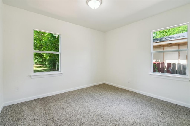 2233 SW 40th St, Oklahoma City, OK 73119 - carpeted spare room featuring healthy amount of natural light and baseboards