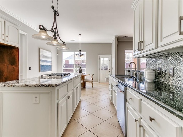 kitchen with ornamental molding, a sink, stainless steel appliances, and tasteful backsplash