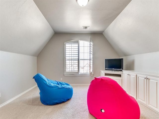 playroom featuring baseboards, visible vents, vaulted ceiling, and carpet