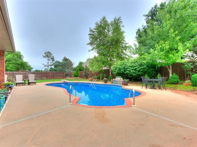 view of swimming pool with a patio, a fenced in pool, a fenced backyard, and outdoor dining area