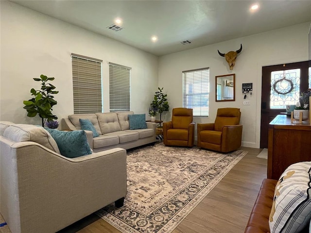 living area featuring visible vents, wood finished floors, and recessed lighting