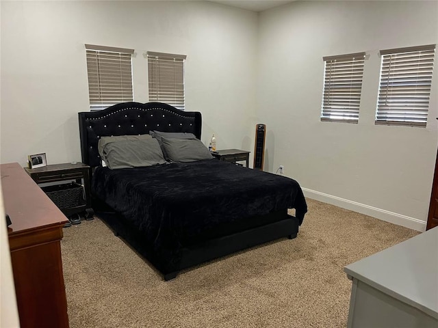 bedroom featuring baseboards and carpet floors