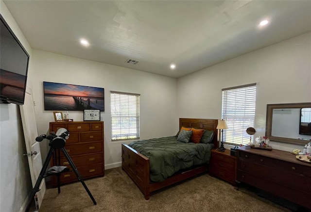 carpeted bedroom with visible vents, baseboards, and recessed lighting