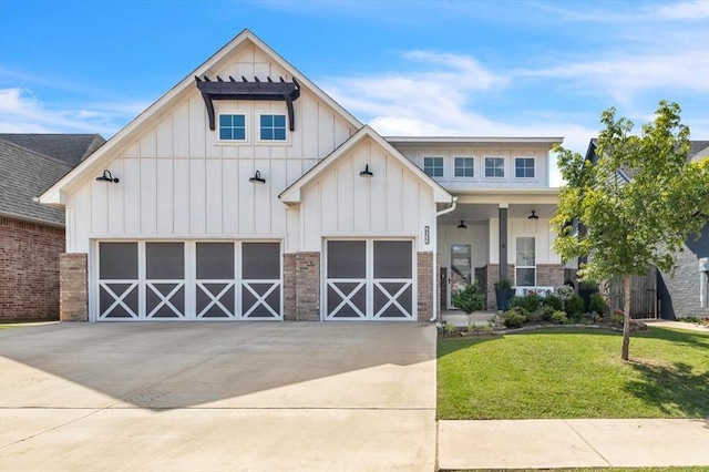 view of front of house with board and batten siding, a front lawn, and driveway