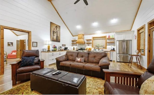 living room featuring high vaulted ceiling, crown molding, ceiling fan, and light wood-type flooring