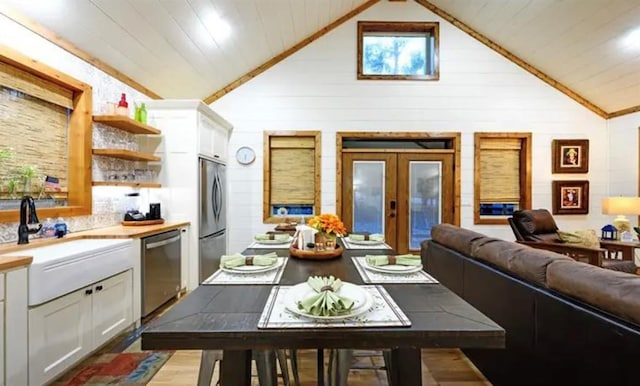 kitchen with appliances with stainless steel finishes, white cabinetry, a sink, open shelves, and french doors