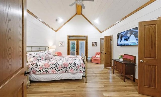 bedroom featuring french doors, high vaulted ceiling, beamed ceiling, ceiling fan, and wood finished floors