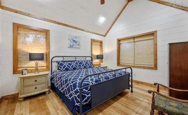 bedroom with lofted ceiling and wood finished floors