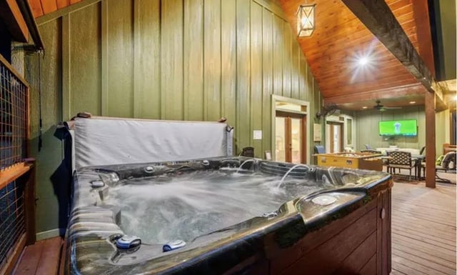 interior space featuring ceiling fan, lofted ceiling, a jacuzzi, wooden ceiling, and wood-type flooring