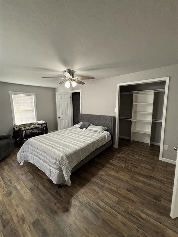 bedroom featuring dark wood-type flooring, ceiling fan, and baseboards