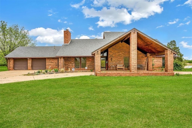 view of front of property featuring an attached garage, a front lawn, brick siding, and concrete driveway