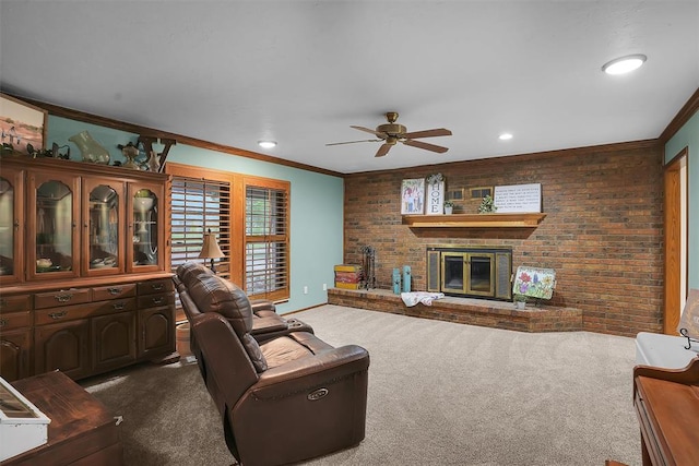 living area featuring carpet, ceiling fan, ornamental molding, a fireplace, and brick wall