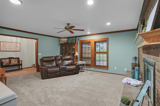 carpeted living room featuring baseboards, recessed lighting, a ceiling fan, crown molding, and a fireplace