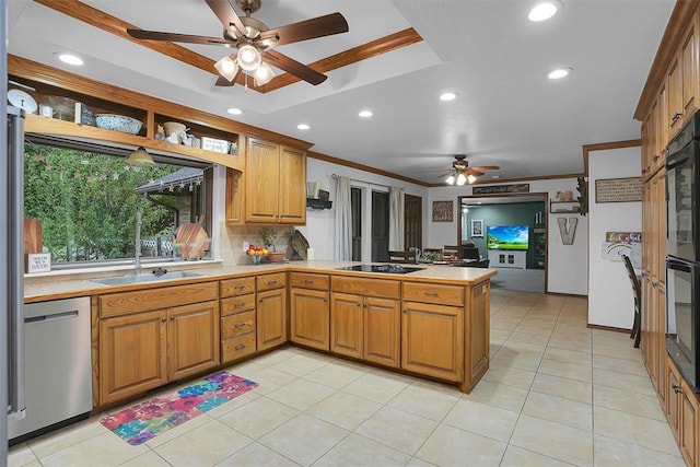 kitchen featuring a peninsula, a raised ceiling, black appliances, ceiling fan, and ornamental molding