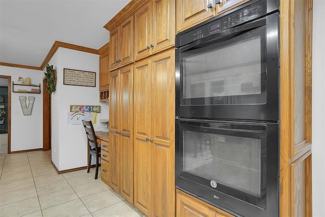 kitchen with ornamental molding, light tile patterned floors, dobule oven black, baseboards, and brown cabinetry