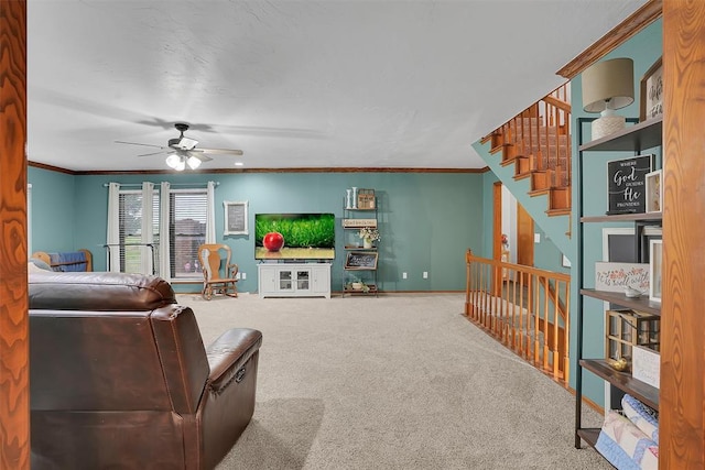 living area with a ceiling fan, baseboards, carpet floors, and ornamental molding