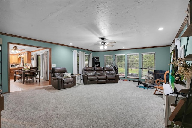 living room featuring light carpet, a ceiling fan, recessed lighting, and crown molding