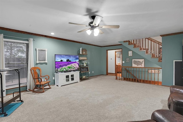 living room with baseboards, ornamental molding, carpet floors, and ceiling fan