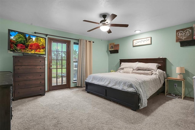 carpeted bedroom featuring ceiling fan and access to outside