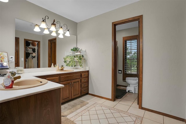 full bath featuring baseboards, tile patterned floors, vanity, and toilet