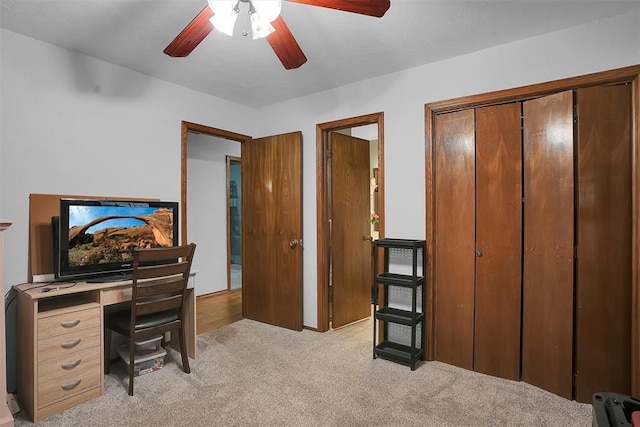 office area with light colored carpet and ceiling fan