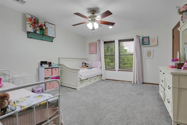 bedroom with light colored carpet, ceiling fan, baseboards, and visible vents