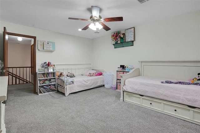 bedroom with carpet floors, visible vents, and a ceiling fan