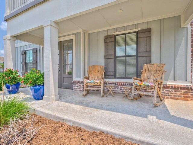 1924 Plaza District Dr, Edmond, OK 73034 - view of exterior entry with covered porch and board and batten siding