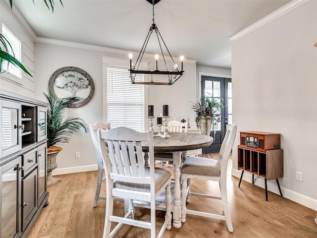 1924 Plaza District Dr, Edmond, OK 73034 - dining space with an inviting chandelier, light wood-style flooring, ornamental molding, and baseboards