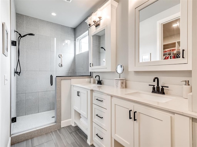 1924 Plaza District Dr, Edmond, OK 73034 - full bathroom featuring double vanity, a sink, and a shower stall