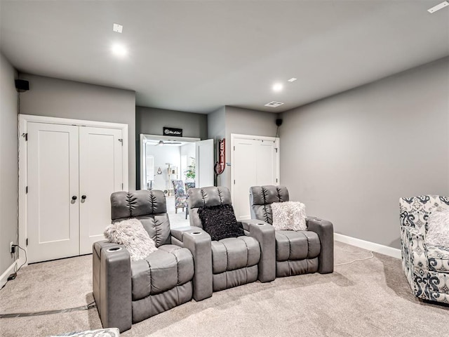 1924 Plaza District Dr, Edmond, OK 73034 - cinema room featuring light carpet, baseboards, and visible vents