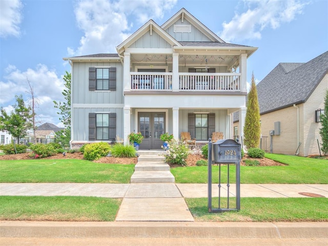 1924 Plaza District Dr, Edmond, OK 73034 - view of front of house featuring french doors, board and batten siding, a balcony, and a front yard