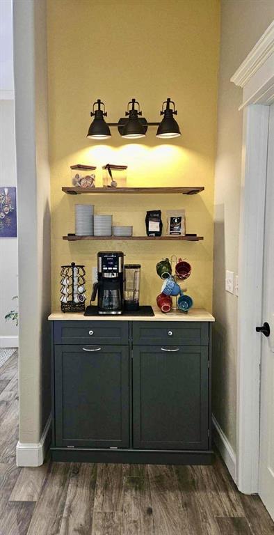 2809 Morgan Trace Rd, Yukon, OK 73099 - indoor dry bar featuring dark wood-type flooring and baseboards