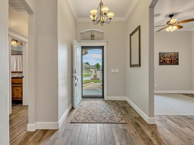 2809 Morgan Trace Rd, Yukon, OK 73099 - foyer entrance with hardwood / wood-style floors, crown molding, a chandelier, baseboards, and ceiling fan