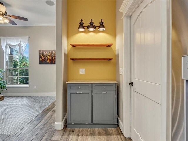 2809 Morgan Trace Rd, Yukon, OK 73099 - bathroom with crown molding, wood finished floors, a ceiling fan, and baseboards
