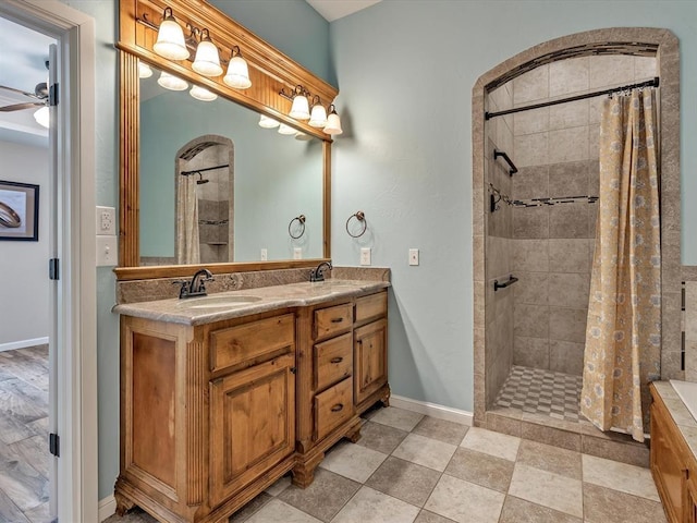 2809 Morgan Trace Rd, Yukon, OK 73099 - full bath featuring double vanity, a ceiling fan, tiled shower, and baseboards