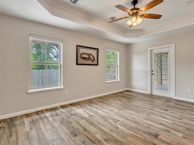 2809 Morgan Trace Rd, Yukon, OK 73099 - unfurnished room featuring a tray ceiling, ornamental molding, wood finished floors, ceiling fan, and baseboards