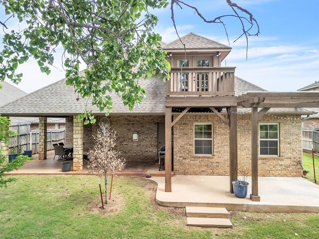 2809 Morgan Trace Rd, Yukon, OK 73099 - rear view of property with a patio area, a shingled roof, and brick siding