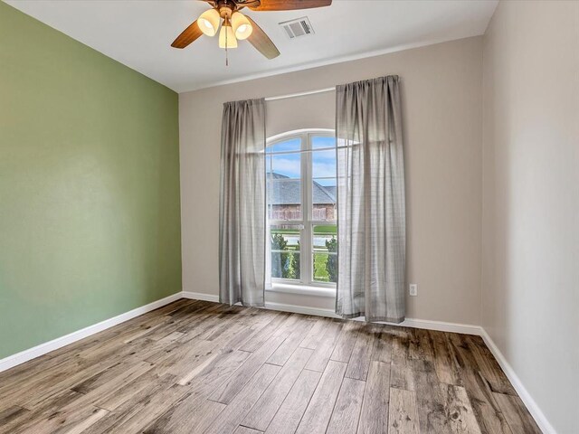 2809 Morgan Trace Rd, Yukon, OK 73099 - unfurnished room featuring wood finished floors, ceiling fan, and baseboards