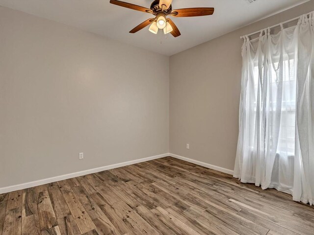 2809 Morgan Trace Rd, Yukon, OK 73099 - spare room featuring ceiling fan, wood finished floors, and baseboards