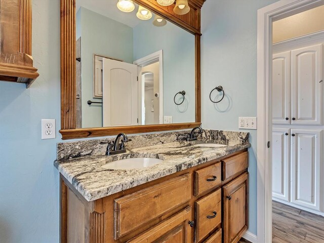 2809 Morgan Trace Rd, Yukon, OK 73099 - full bath featuring double vanity and wood finished floors