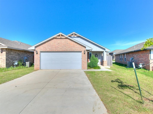3721 Central Park Dr, Moore, OK 73160 - ranch-style home featuring brick siding, board and batten siding, cooling unit, a front lawn, and driveway