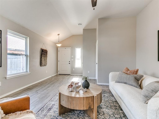 3721 Central Park Dr, Moore, OK 73160 - living room with healthy amount of natural light, light wood-style flooring, lofted ceiling, a ceiling fan, and baseboards