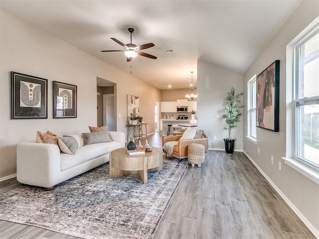3721 Central Park Dr, Moore, OK 73160 - living area with a chandelier, light wood-style flooring, lofted ceiling, ceiling fan, and baseboards