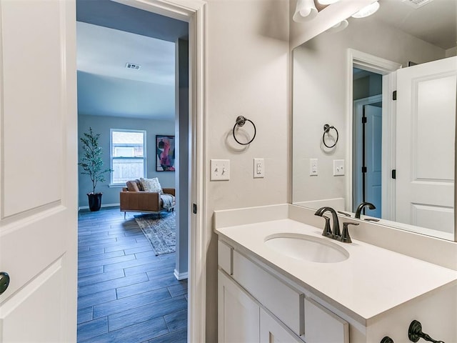 3721 Central Park Dr, Moore, OK 73160 - bathroom with wood finished floors, baseboards, and vanity