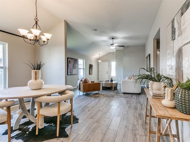 3721 Central Park Dr, Moore, OK 73160 - dining room with vaulted ceiling, a chandelier, light wood-type flooring, and a ceiling fan